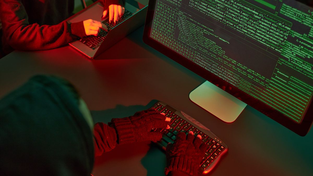 A close-up shot of hackers operating computers.
